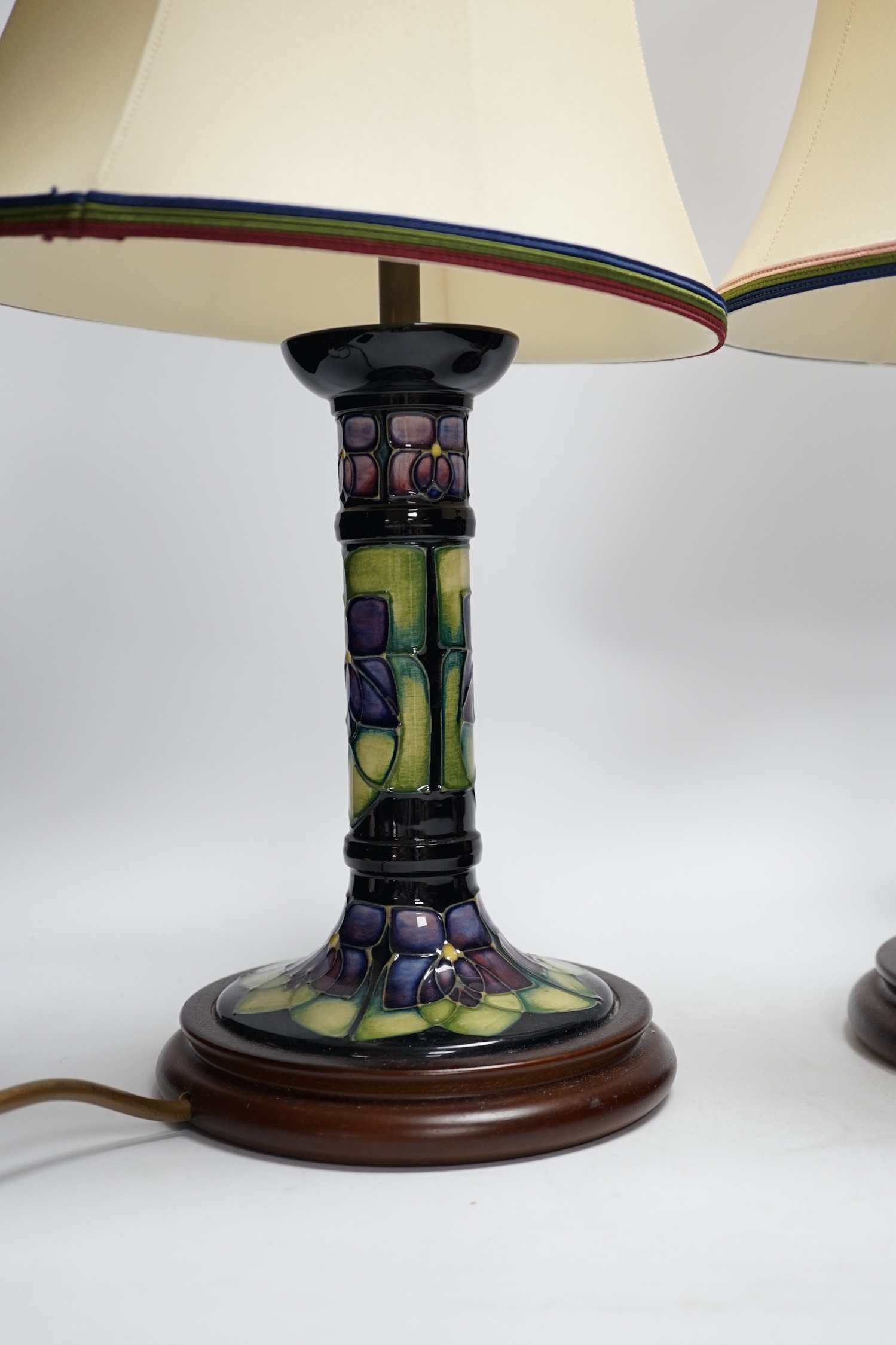 Two Moorcroft lamp bases, in Oberon and Violet patterns, 47cm high